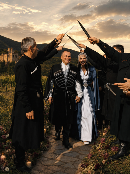 Georgian newlyweds walking beneath a sword arch