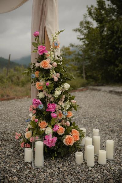 Colourful floral arrangement with candles