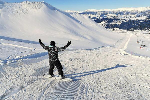 Snowboarder enjoying fresh powder on Goderdzi slopes, Georgia