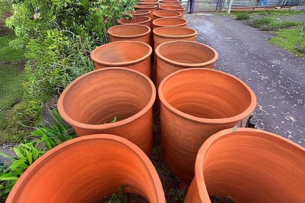Large Qvevri clay vessels drying outdoors at a traditional pottery workshop in Guria, Georgia