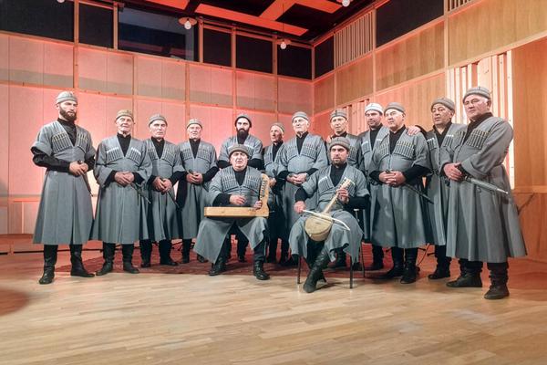 Svan men in traditional Georgian costumes performing songs with ch’uniri & harp instruments, Mestia