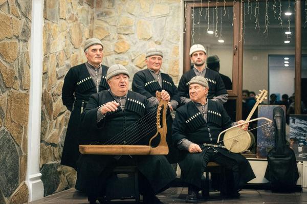 Svan musicians performing traditional Georgian songs with ch’uniri and harp instruments in Mestia