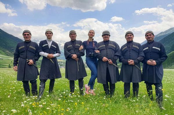 Svan performers in traditional Georgian costumes posing in a mountain meadow near Mestia, Svaneti