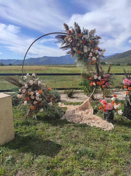 Circular wedding arch with colourful flowers