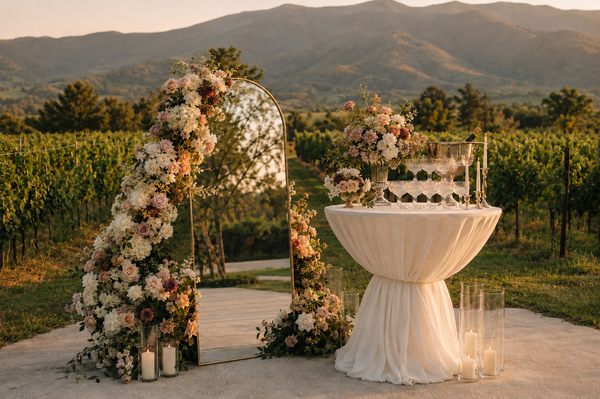 Champagne tower beside a floral mirror installation