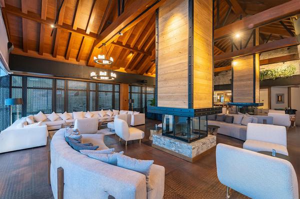 Elegant lounge with central fireplace at Ambassadori Goderdzi