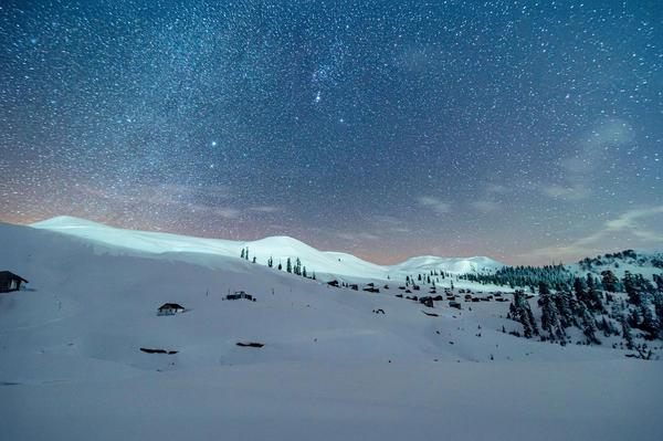 Starry winter night over snowy Goderdzi mountains, Georgia